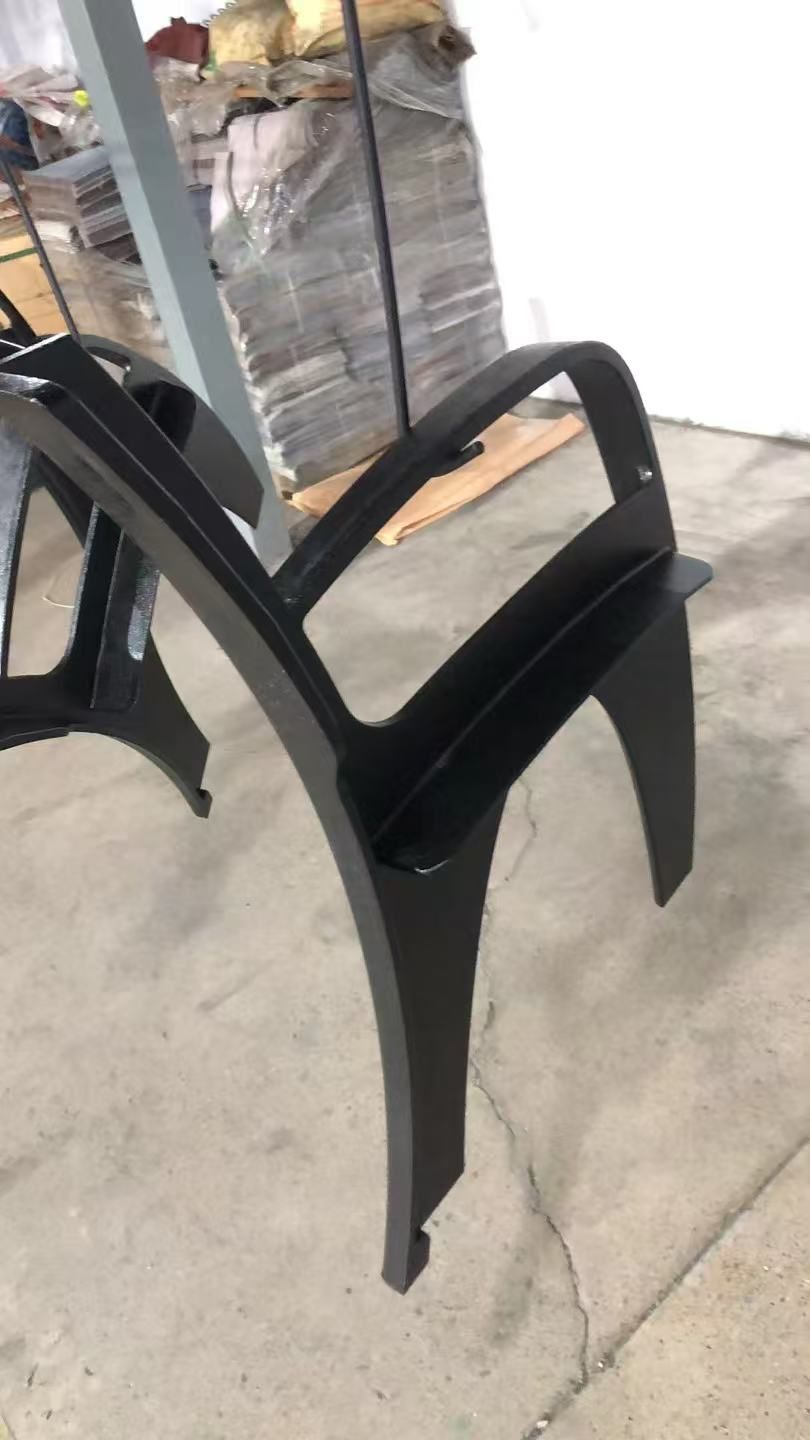 Black cast iron bench end with a curved armrest