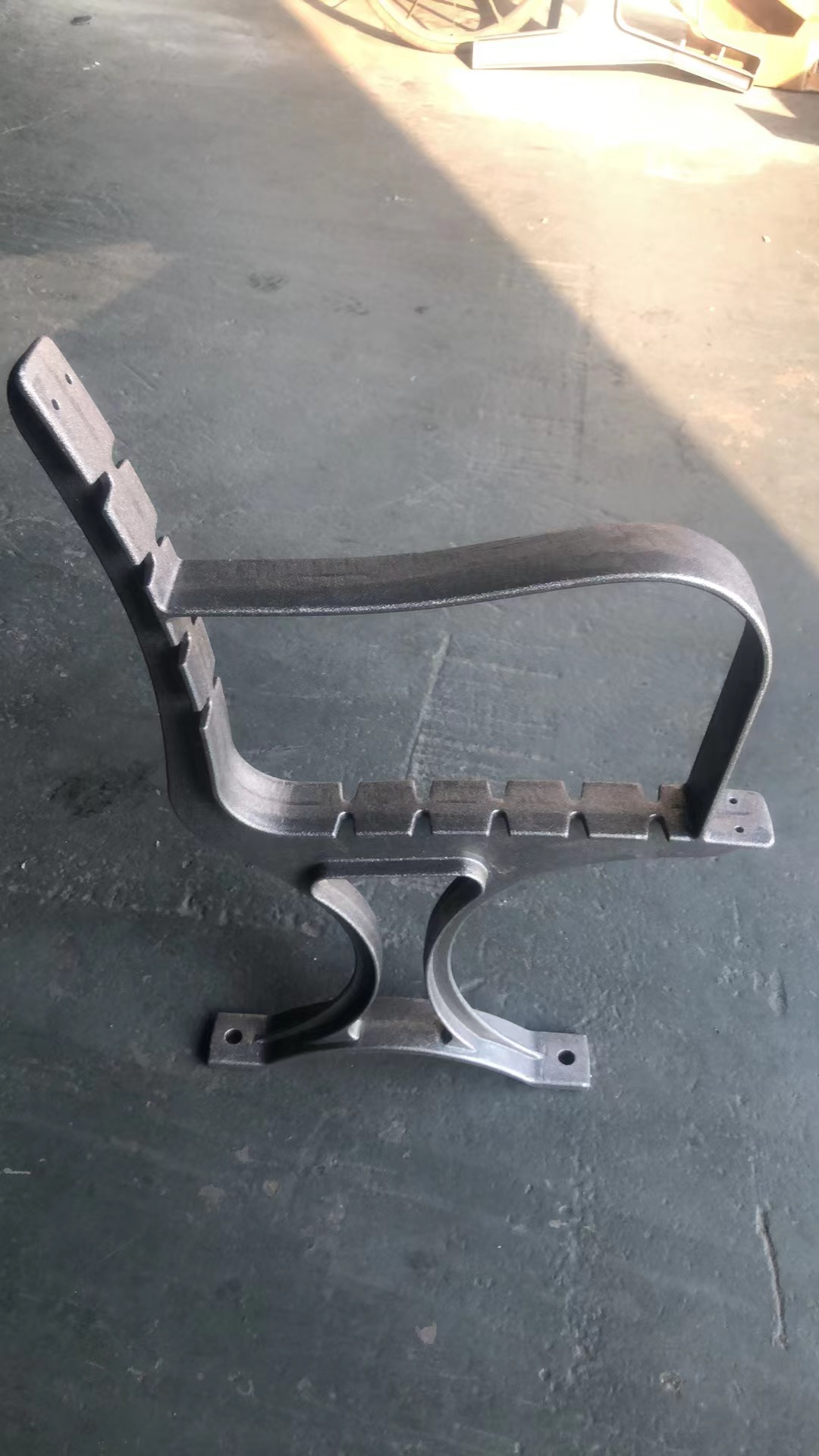 Cast iron bench end with armrest and backrest bracket in the workshop