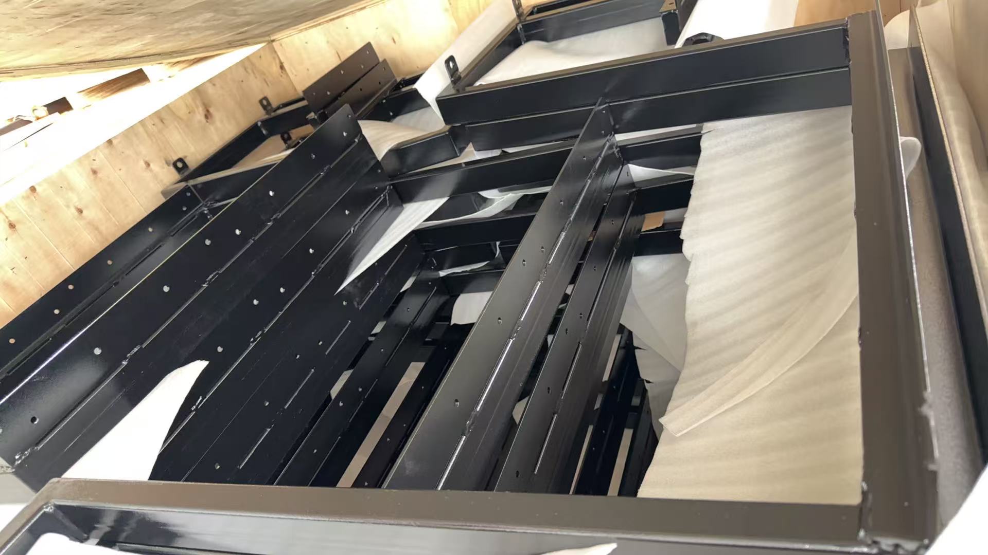 Steel picnic table frame parts packed in the Hannah workshop